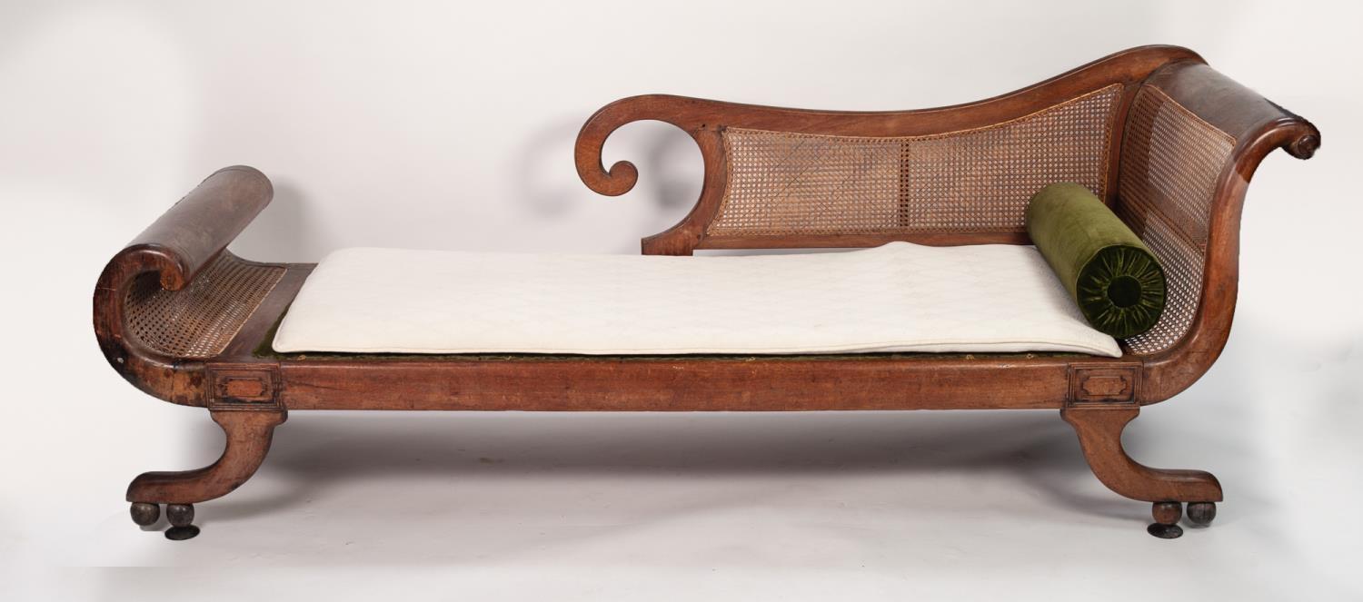 PROBABLY COLONIAL REGENCY TEAKWOOD AND CANED SCROLL END CHAISE LONGUE, with cane work back and seat,