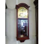 MODERN 'AMS' WALL CLOCK IN MAHOGANY CASE WITH GILT DIAL AND PENDULUM