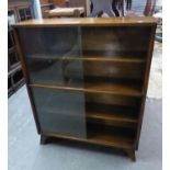 A TEAK BOOKCASE WITH GLASS SLIDING DOORS, 3' WIDE AND A 1960's LOUNGE CHAIR WITH TEAK PANEL SIDES (