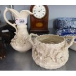 A SMALL BELLEEK JUG WITH DELICATE FLORAL EMBOSSED DECORATION AND A SMALL TWO HANDLED BELLEEK DISH,