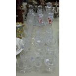 THREE CUT GLASS DECANTERS AND VARIOUS DRINKING GLASSES