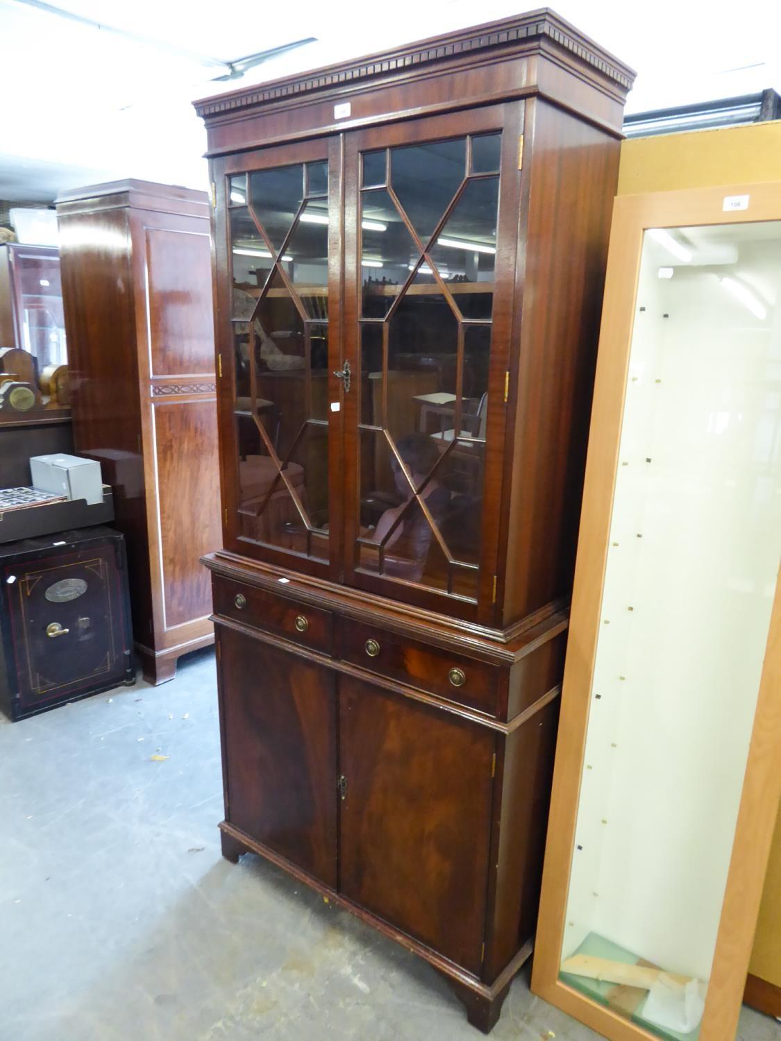 MAHOGANY REPRODUCTION LIBRARY BOOKCASE, THE BASE HAVING TWO DRAWERS ABOVE TWO CUPBOARD DOORS AND THE