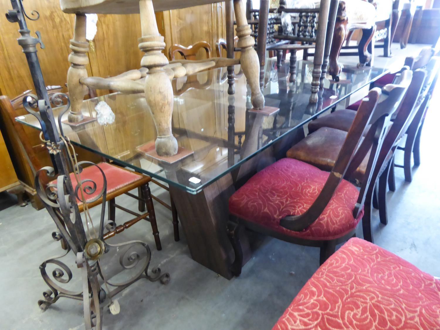 A LARGE MODERN OBLONG GLASS TOP DINING TABLE