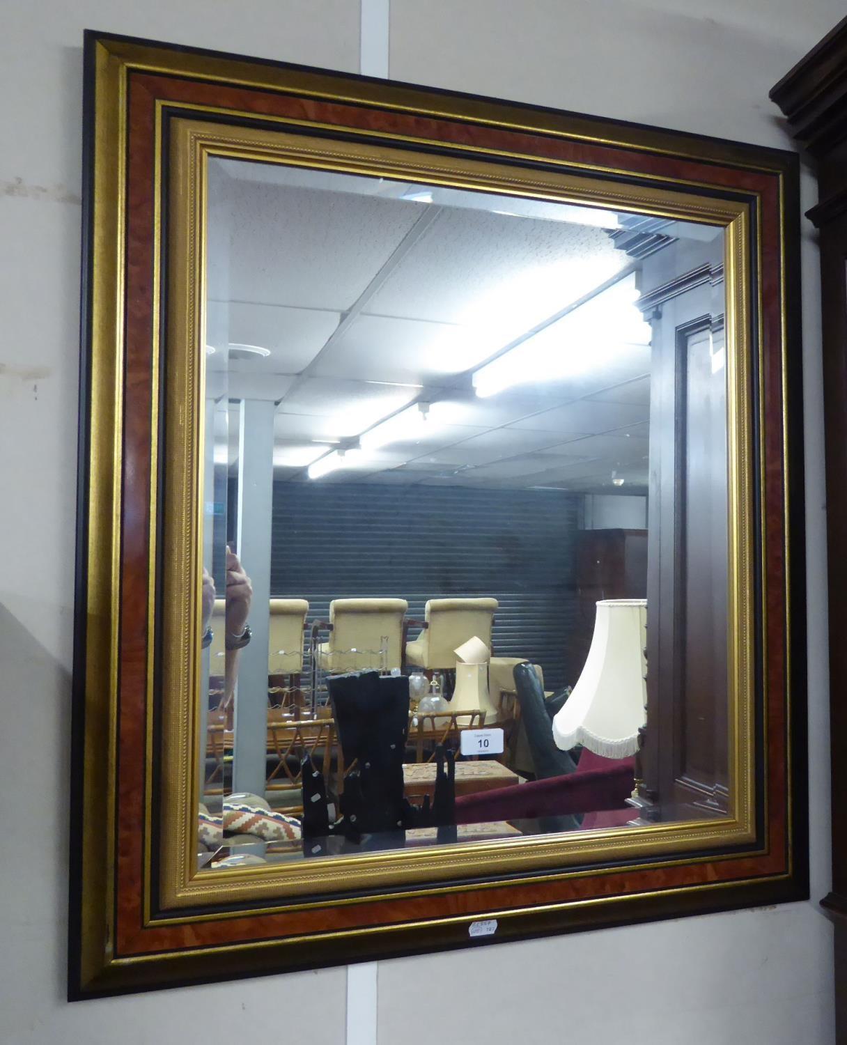 A RECTANGULAR BEVELLED EDWAR WALL MIRROR, IN WALNUT AND GILT CAVETTO FRAME, 2'6" X 2'3" OVERALL