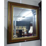 A RECTANGULAR BEVELLED EDWAR WALL MIRROR, IN WALNUT AND GILT CAVETTO FRAME, 2'6" X 2'3" OVERALL