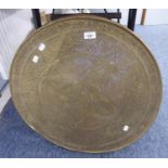 A CIRCULAR BRASS WALL PLAQUE WITH DECORATION