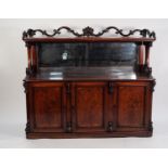 EARLY NINETEENTH CENTURY CARVED AND FIGURED MAHOGANY BUFFET SIDEBOARD, the rounded oblong top