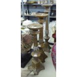 A SET OF THREE LATE TWENTIETH CENTURY GRADUATED FLOOR CANDLESTICK STANDS (3)