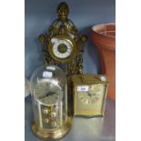 AN ORNATE MODERN GILT METAL MANTEL CLOCK WITH WIND UP MECHANISM AND AN ANNIVERSARY CLOCK UNDER A