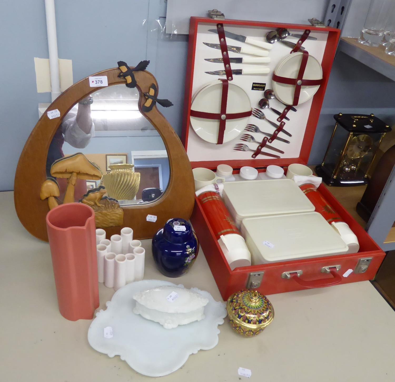 A TEAK EASEL MIRROR, THE FRAME CARVED WITH A FROG AND TOADSTONES AND SIRRAM PICNIC HAMPER IN HARD