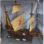A WOODEN MODEL OF A SPANISH GALLEON UNDER SAIL