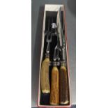 A THREE PIECE CARVING SET WITH HORN HANDLES