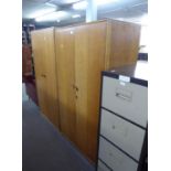 A PAIR OF 1950's LIGHT OAK TWO DOOR WARDROBES AND A SUNK CENTRE DRESSING TABLE (LACKS MIRRORS (3)