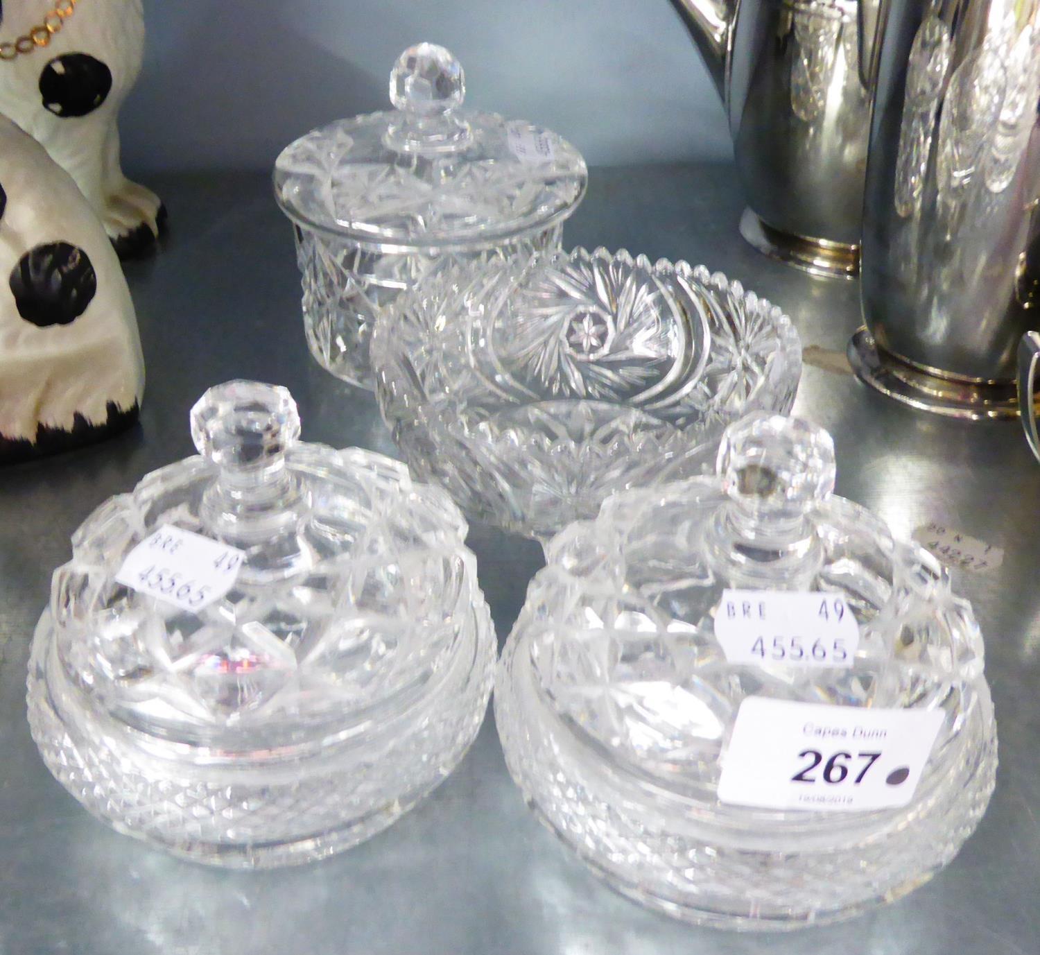 A PAIR OF 20TH CENTURY CUT GLASS CIRCULAR TRINKET DISHES WITH COVERS, POWDER JAR ANS COVER AND A