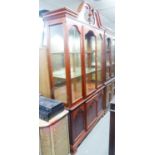 GEORGIAN STYLE MAHOGANY DISPLAY CABINET WITH BROKEN ARCH PEDIMENT, MIRRORED INTERIORS, CUPBOARD BASE