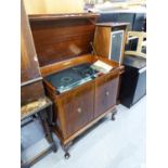 DYNATRON RADIOGRAM IN MAHOGANY CABINET WITH LIFT-UP TOP, TWO DOORS BELOW ENCLOSING RECORD STORAGE