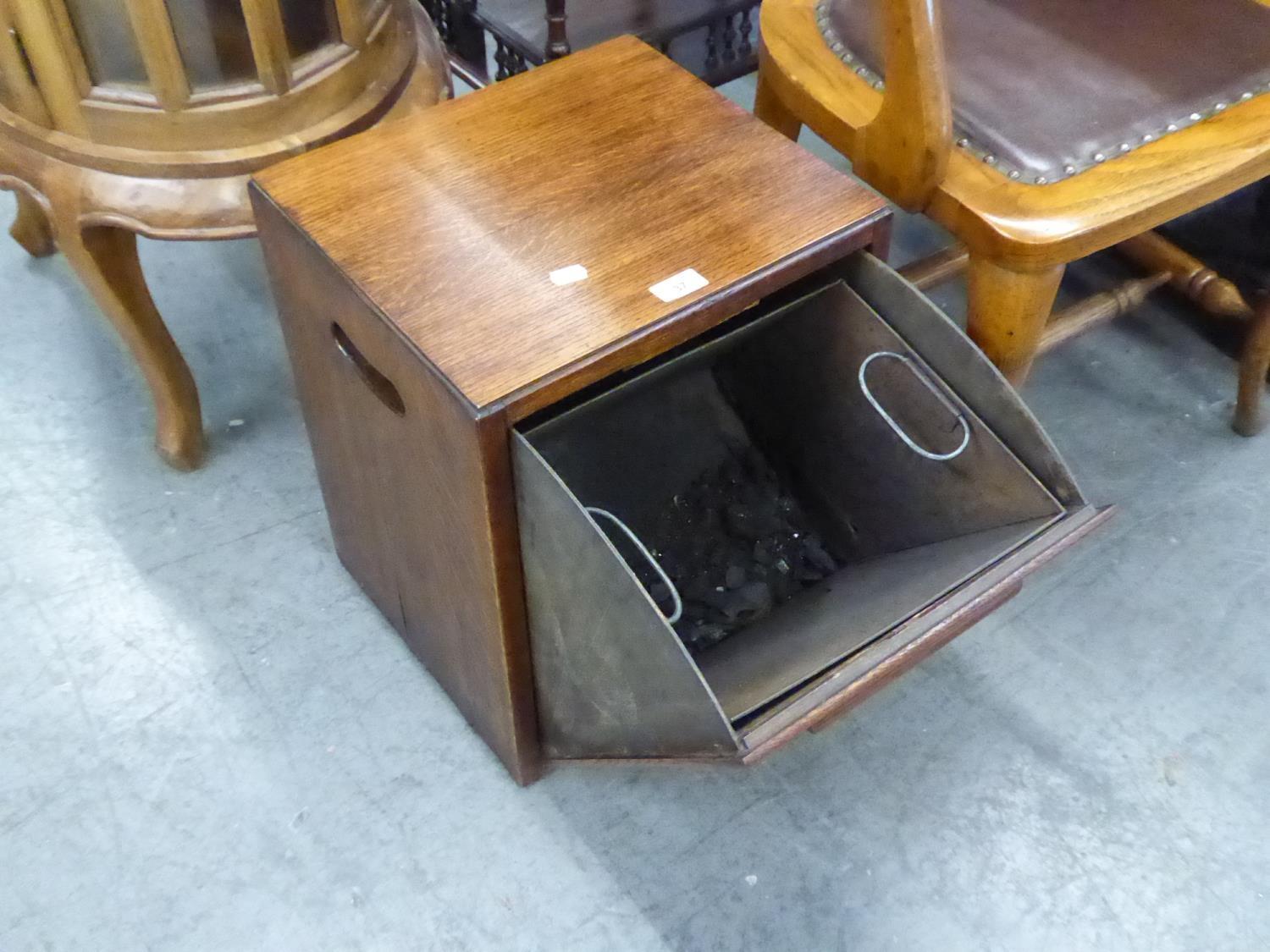 A MID TWENTIETH CENTURY OAK CASED COAL PURDOMIUM WITH METAL LINER