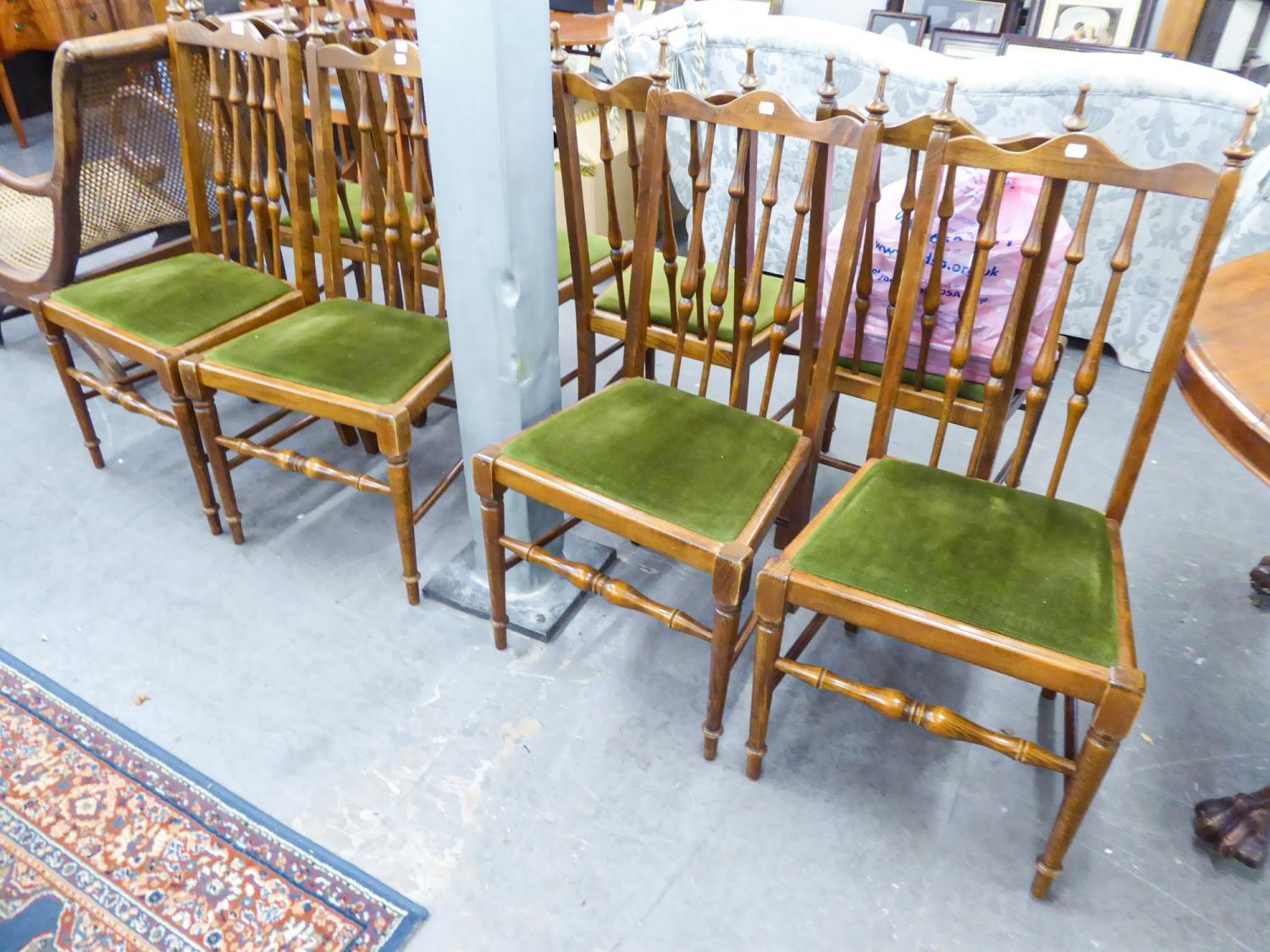 SET OF FOUR HARDWOOD SINGLE CHAIRS EACH WITH TALL SPINDLE BACKS AND DROP-IN SEATS IN GREEN PLUSH