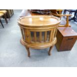 A MAHOGANY OVAL SHAPED DISPLAY CABINET HAVING GLASS PANELS AND LIFT-OFF TRAY