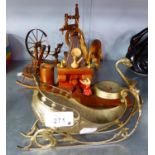 A SILVERED METAL SLEIGH ORNAMENT, TWO MODEL SPINNING WHEELS, A MODEL ROCKING CHAIR, TWO PLASTIC