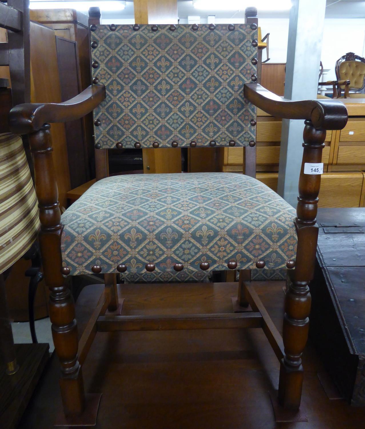 A SET OF FIVE OAK DINING CHAIRS OF COMMONWEALTH STYLE, WITH UPHOLSTERED BACK PANELS AND STUFFED OVER