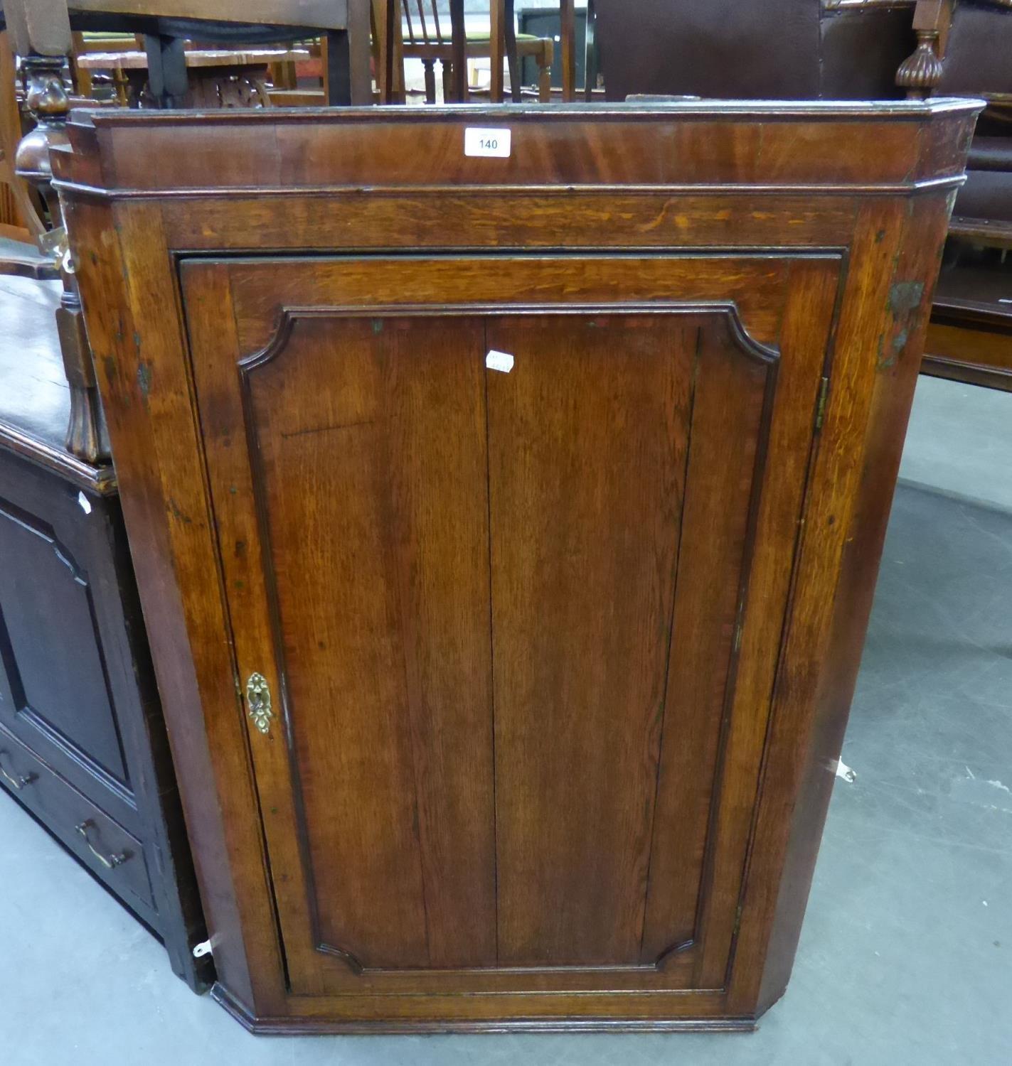 A LARGE GEORGE III OAK AND MAHOGANY CROSSBANDED HANGING CORNER CUPBOARD