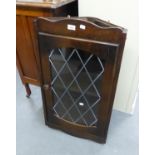 A SMALL OAK CORNER CUPBOARD WITH LEAD GLAZED DOOR AND AN OAK NEST OF THREE COFFEE TABLES (2)