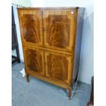 A FRAMED MAHOGANY COCKTAIL CABINET, HAVING FOUR DOORS, THE TOP SECTION HAVING GLASS SHELF AND PULL-