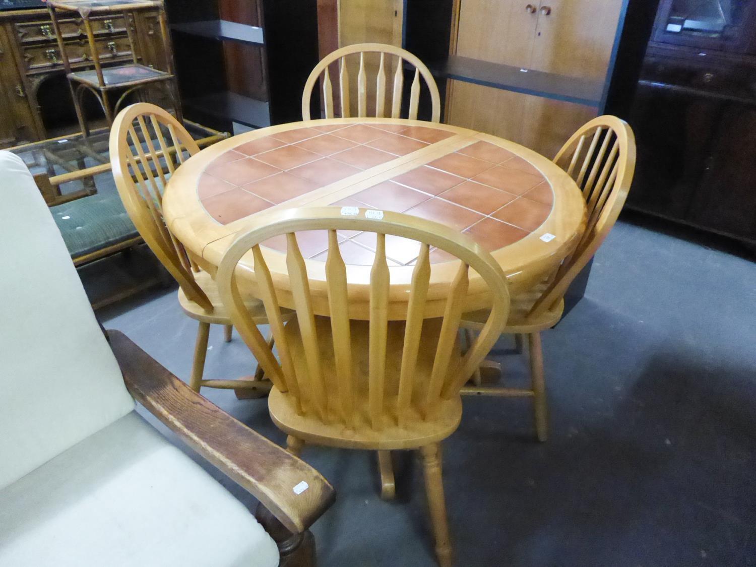 A BEECHWOOD CIRCULAR EXTENDING DINING TABLE, WITH HEATPROOF TOP, WITH FOLDING LEAF BELOW, ON