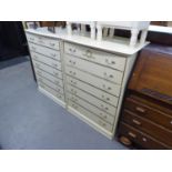 A PAIR OF CREAM COLOURED SEVEN DRAWER CHEST WITH GILT HANDLES (2)
