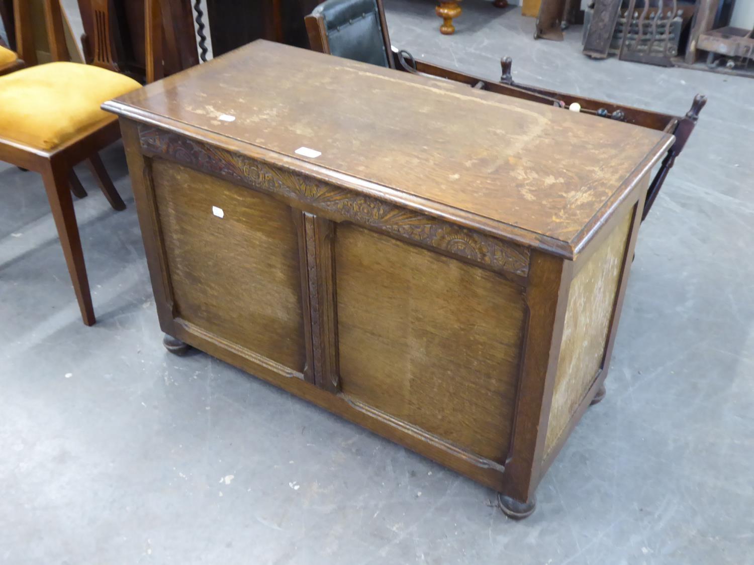 A mid 20th Century oak bedding chest of solid form, on bun feet