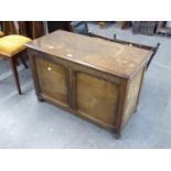 A mid 20th Century oak bedding chest of solid form, on bun feet