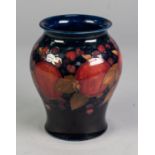 WILLIAM MOORCROFT POTTERY INVERTED BALUSTER SHAPE VASE, pomegranate and berry decorated, on a dark