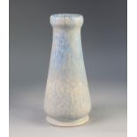 RUSKIN POTTERY VASE, of footed, tapering form with swollen rim, matt glazed in mottled pale blue,