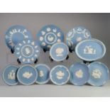 SEVENTEEN WEDGWOOD PALE BLUE JASPERWARE PLATES, sprigged in white, including: SIX CHRISTMAS