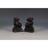 PAIR OF CHINESE CARVED BLACK ALABASTER MODELS OF DOGS OF FO, each typically modelled on an oblong