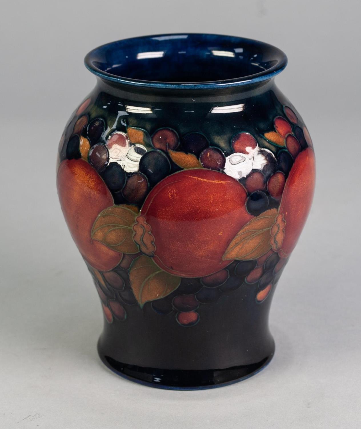 WILLIAM MOORCROFT POTTERY INVERTED BALUSTER SHAPE VASE, pomegranate and berry decorated, on a dark - Image 2 of 4