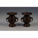 PAIR OF JAPANESE MEIJI PERIOD TWO HANDLED BRONZE SMALL VASES, each of footed form with flared rim