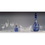 AN OVAL BOAT SHAPE CUT GLASS BOWL, A CUT A SAPPHIRE BLUE FLASHED DECANTER, a smaller ditto and
