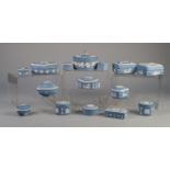 FIFTEEN WEDGWOOD PALE BLUE JASPERWARE BOXES AND COVERS, sprigged in white, mainly with classical