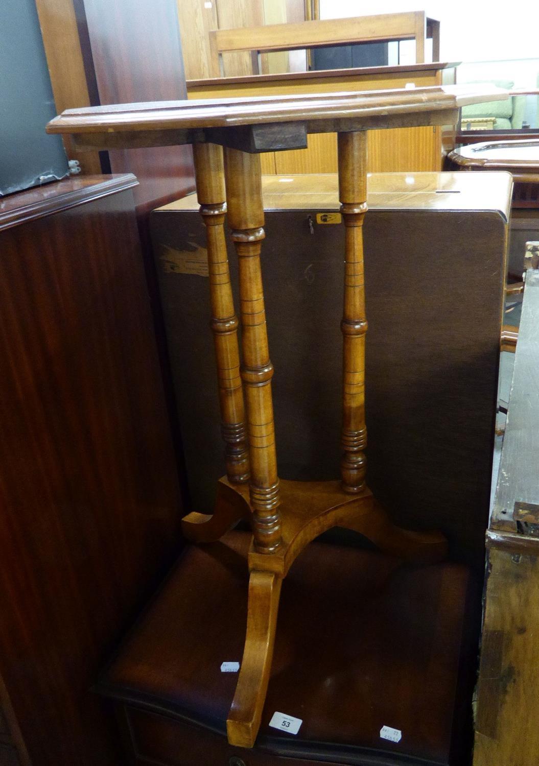 A LATE VICTOIRAN WALNUT OCTAGONAL OCCASONAL TABLE ON THREE TURNED LEGS ON TRIFORM PLATFORM WITH