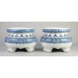 PAIR OF MODERN CHINESE BLUE AND WHITE PORCELAIN VASE OR URN STANDS, each of circular form with three