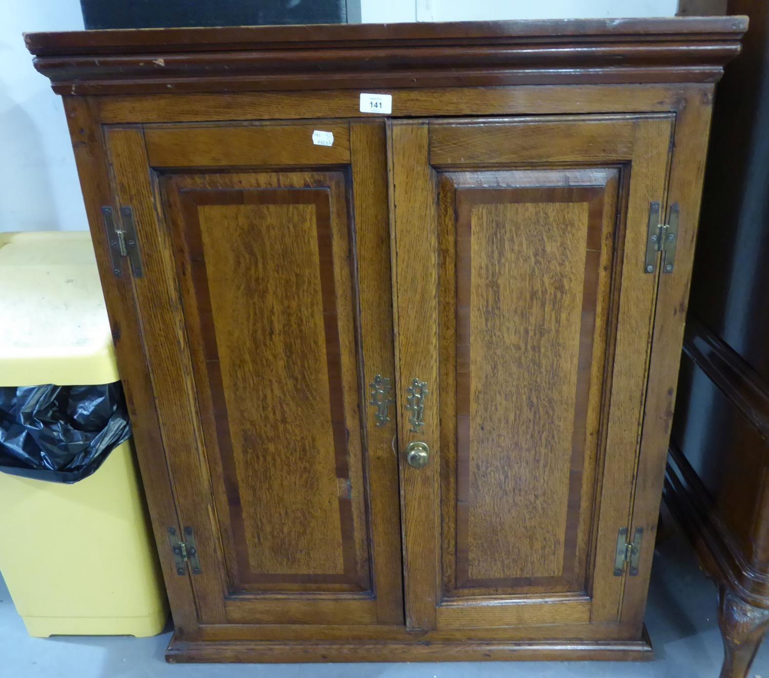 AN ANTIQUE OAK TWO DOOR DWARF CUPBOARD WITH 'H' HINGES, QUADRANT PILASTER FORECORNERS ON LATER