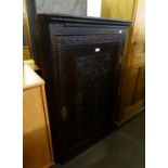 AN ANTIQUE OAK CARVED CORNER CABINET