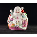 CHINESE PORCELAIN ?LAUGHING BUDDHA? HOTEI GROUP, painted in colours and modelled with five children,