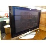 A 42" PANASONIC FLAT SCREEN TV ON STAND (NO REMOTE)