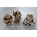 THREE JAPANESE MEIJI PERIOD CARVED IVORY NETSUKE, comprising; TWO STREET VENDORS, one heightened
