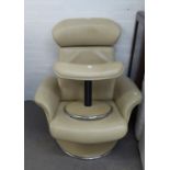 A CREAM LEATHER REVOLVING EASY ARMCHAIR AND A MATCHING FOOTSTOOL