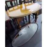 AN OAK OVAL OCCASIONAL TABLE AND AN OVAL WALL MIRROR IN OXYDISED COPPER FRAME (2)