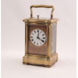 EARLY 20th CENTURY FRENCH SERPENTINED GORGE CASED BRASS REPEATER CARRIAGE CLOCK, gilded brass